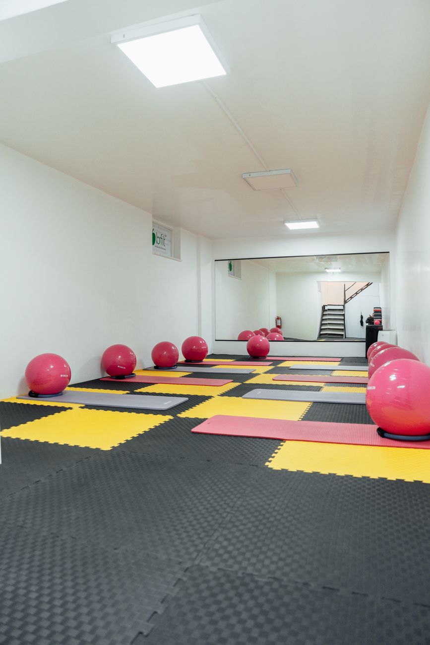 pink balls and yoga mats at gym