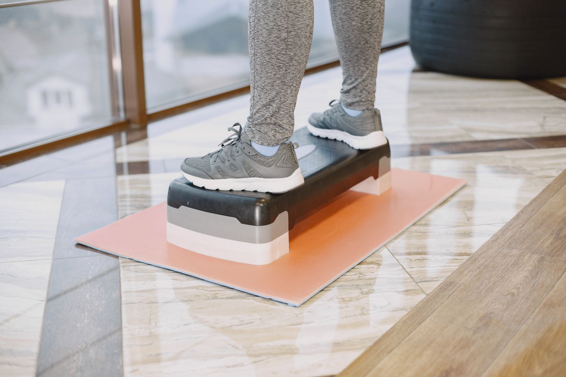 person standing on step at gym